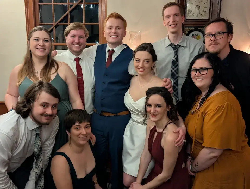 A photo showcasing examples of the dresscode. Wedding guests are wearing cocktail attire.